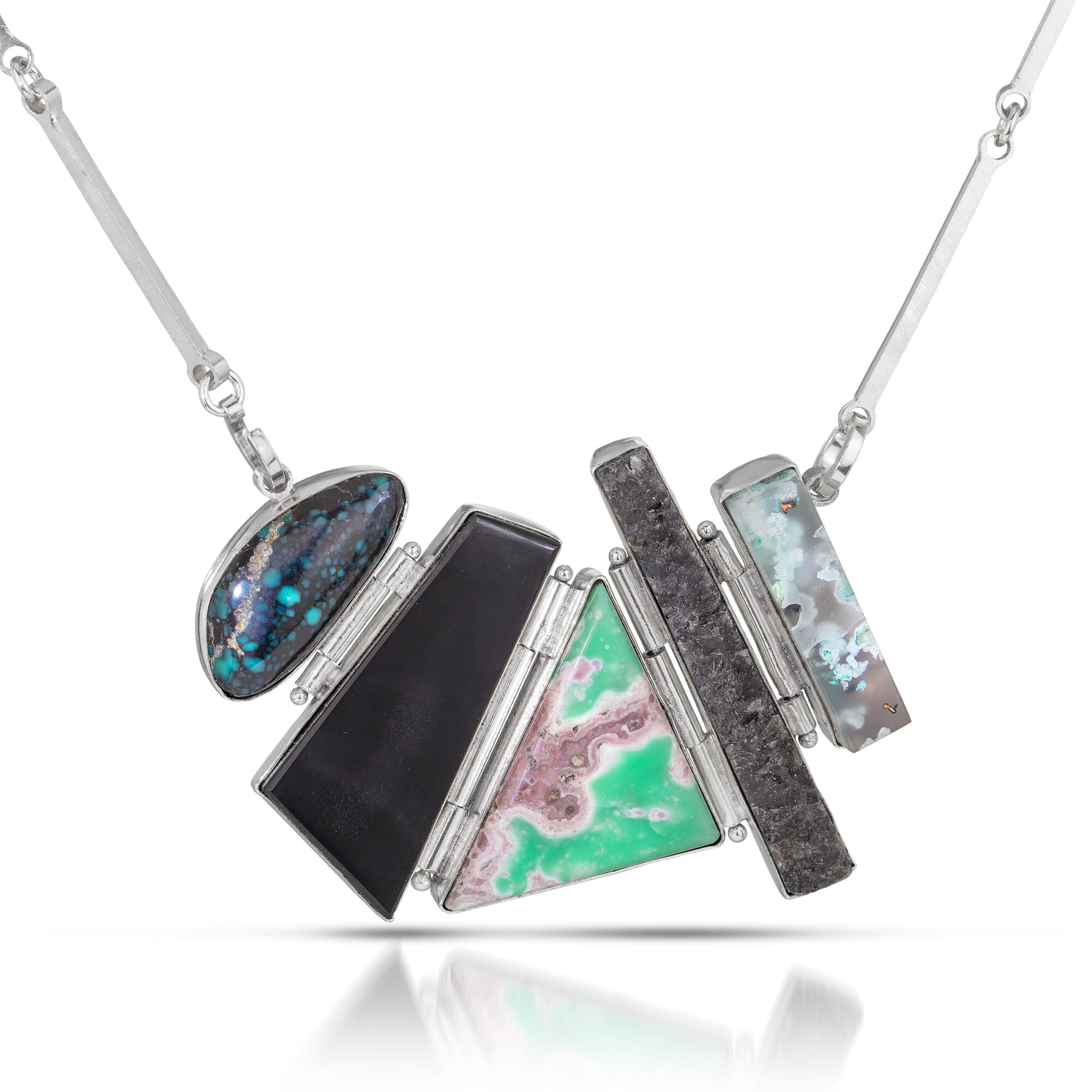 Necklace with five rectangular and oval pendants in various colors and patterns, hanging from a chain.