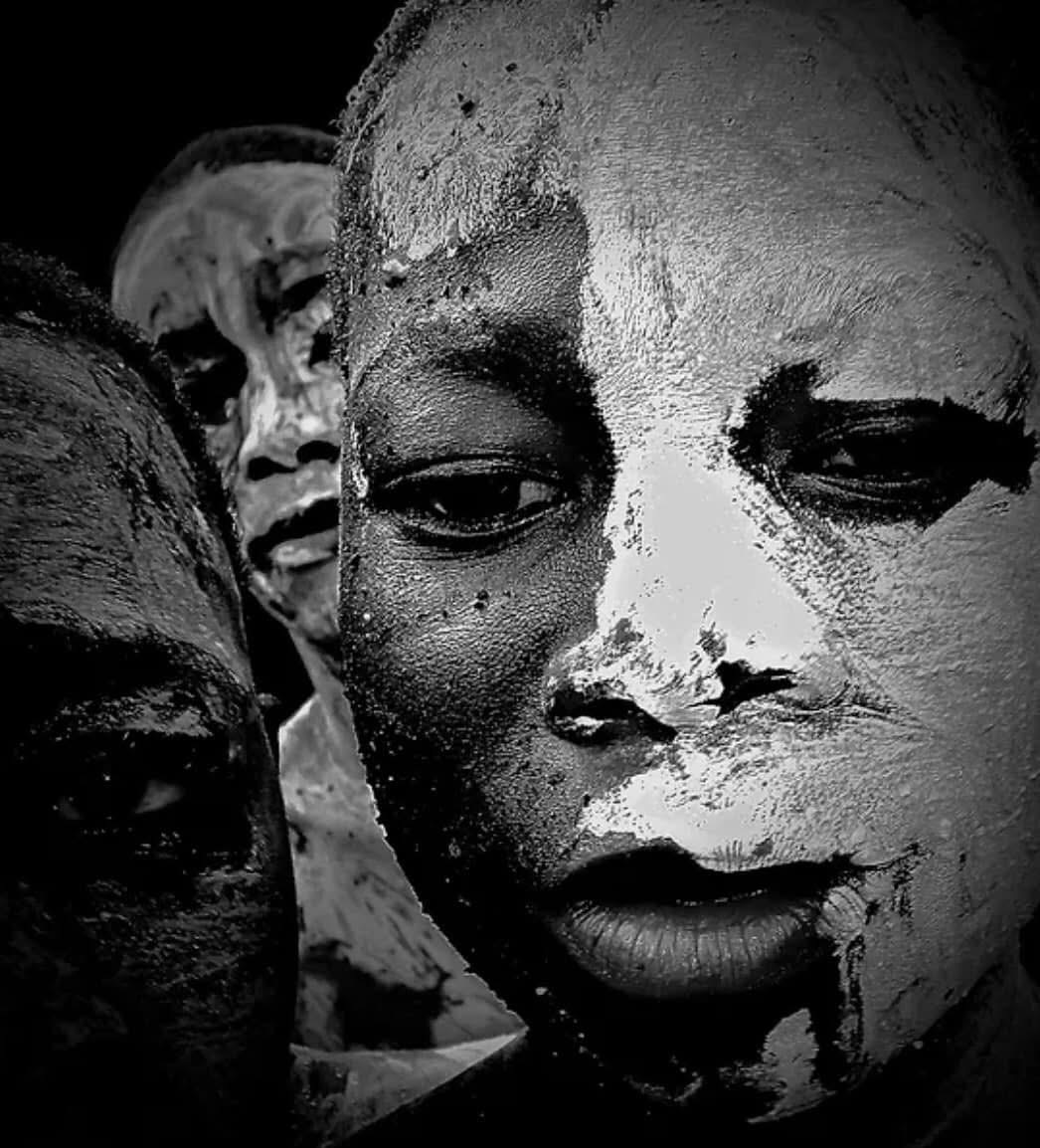 Three children with painted faces, close-up, black and white, serious expressions, detailed facial features, textured paint, dark background.