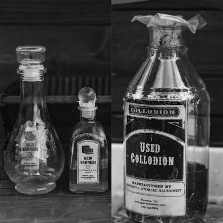 Three glass bottles, two small and one large, with labels, on a dark background.
