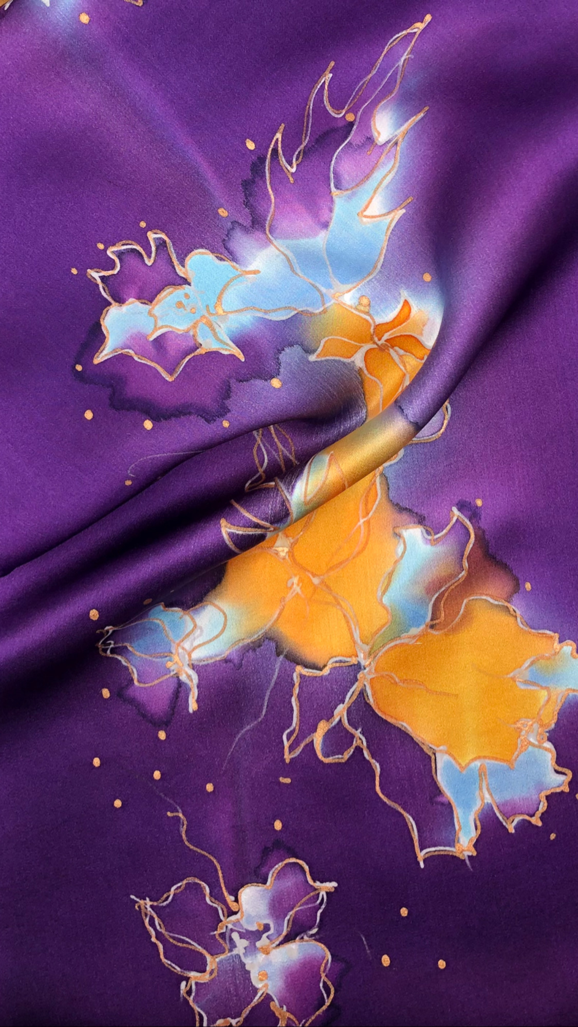 Abstract colorful design with purple, blue, orange, and gold elements on a purple background.