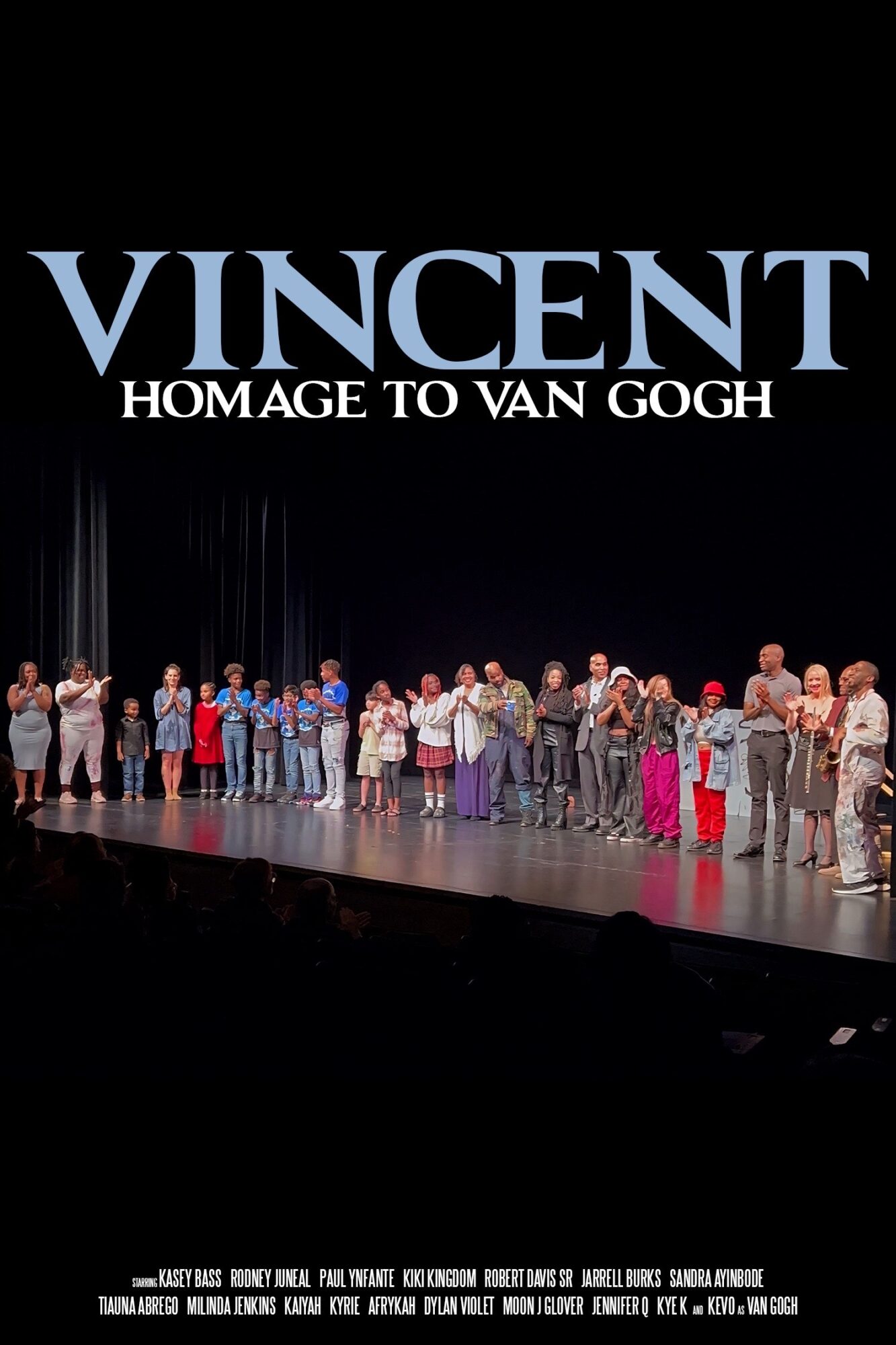 Group of children and adults on stage, with large text reading 'VINCENT HOMAGE TO VAN GOGH' above them.