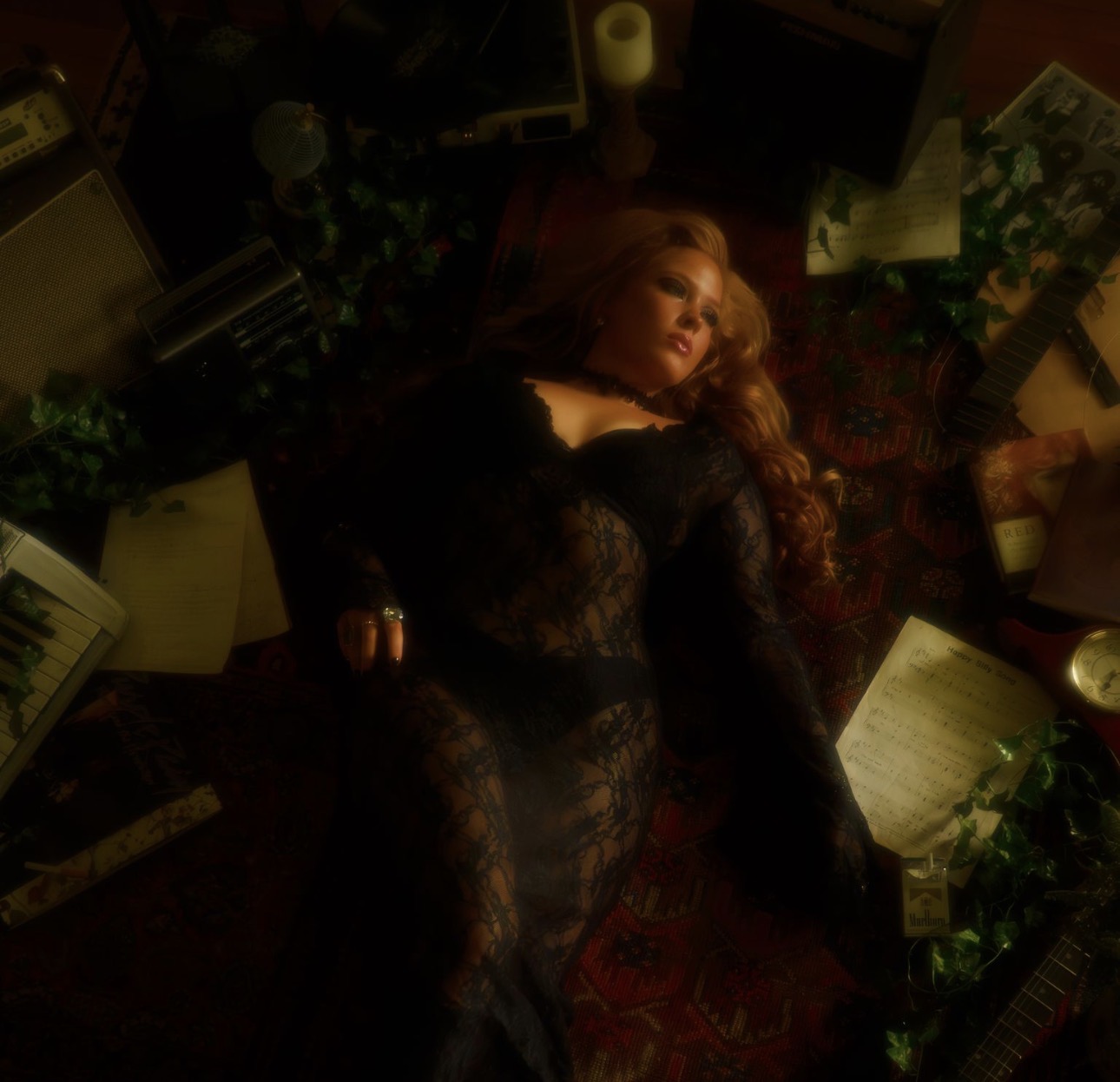 Woman lying on a patterned rug surrounded by books and plants, wearing black lace clothing.