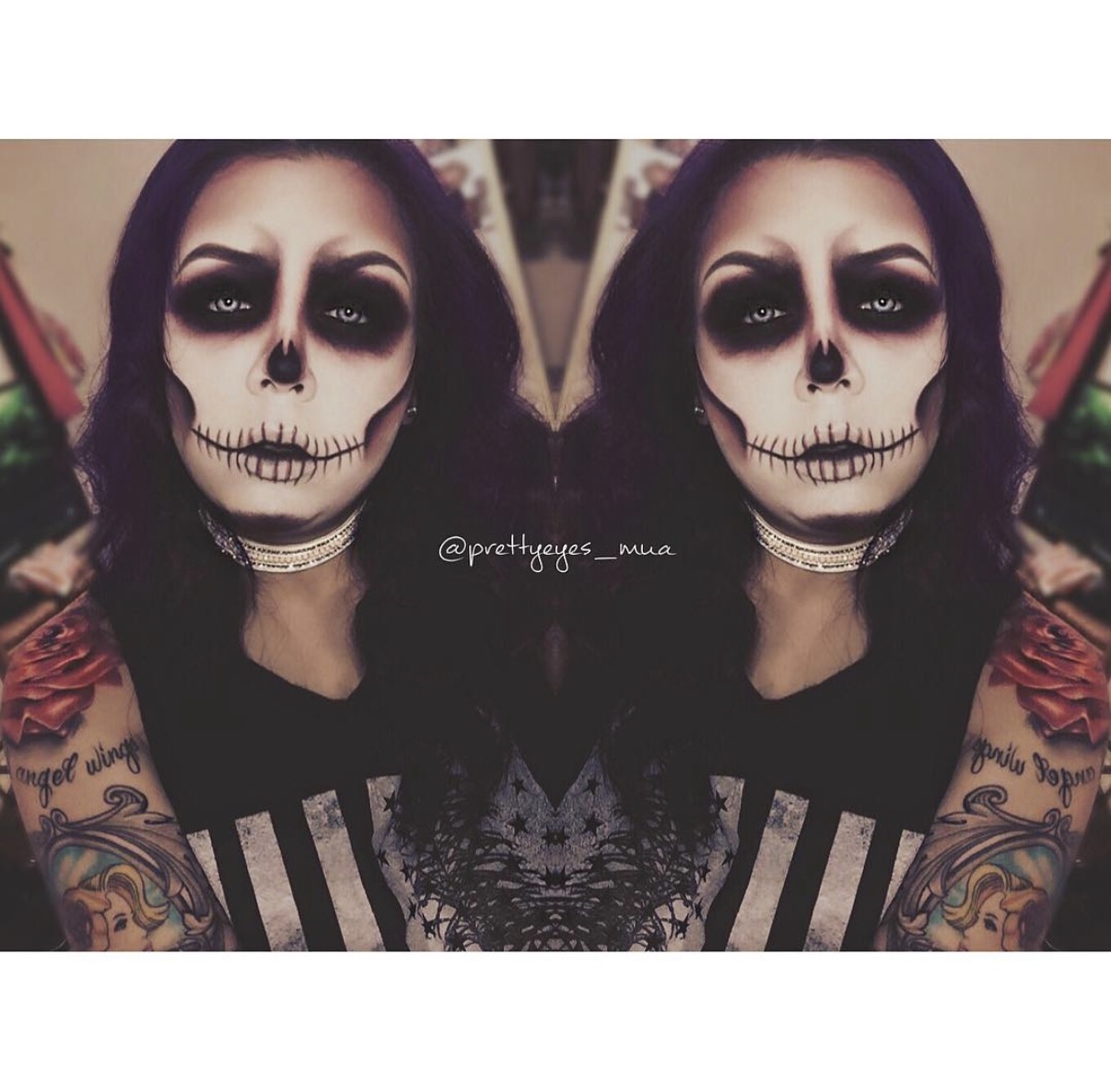 Person with skull makeup, dark eye makeup, and tattoos on arms, wearing a striped shirt and choker necklace.
