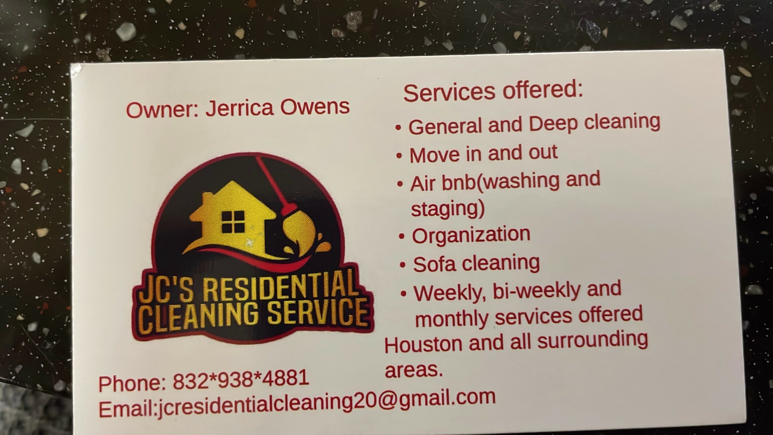 Business card with red text, yellow house logo, and contact information, listing cleaning services offered.