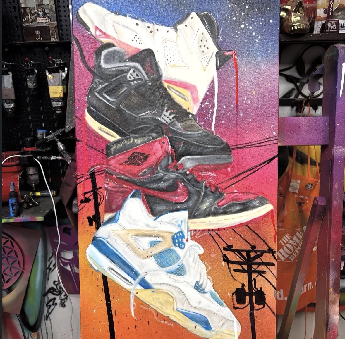 Colorful graffiti of four sneakers stacked vertically on a vibrant background with abstract lines.
