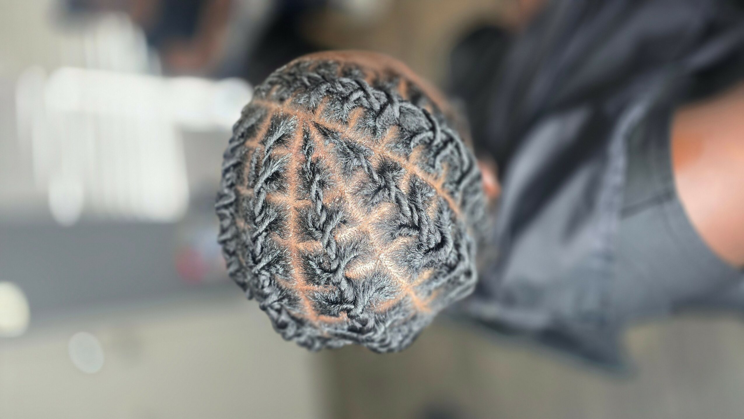 Top view of a child's braided hairstyle with intricate patterns.