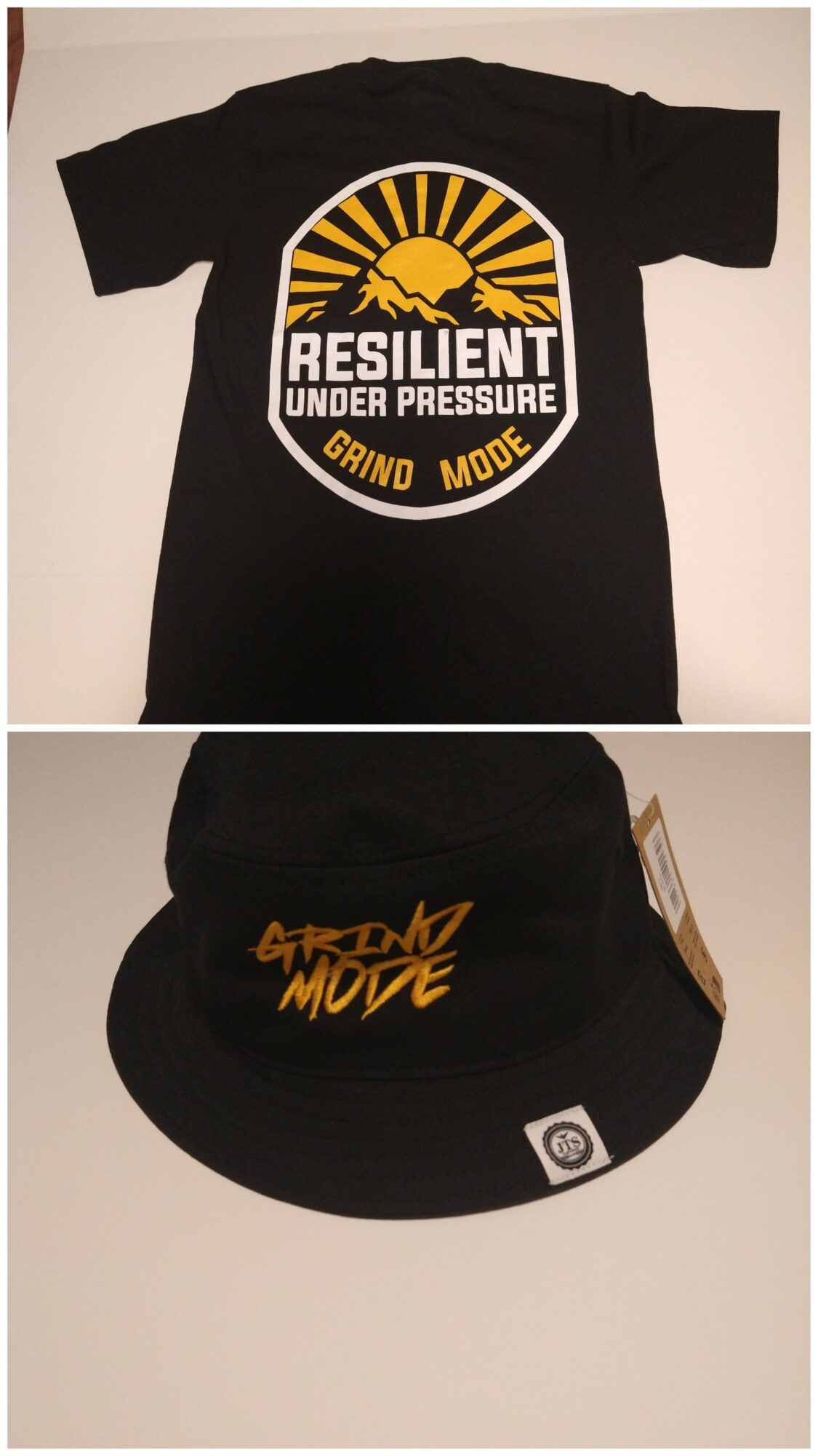 Black T-shirt with a graphic design reading 'Resilient Under Pressure' and a yellow sunburst, and a black cap with 'Grind Mode' in yellow.