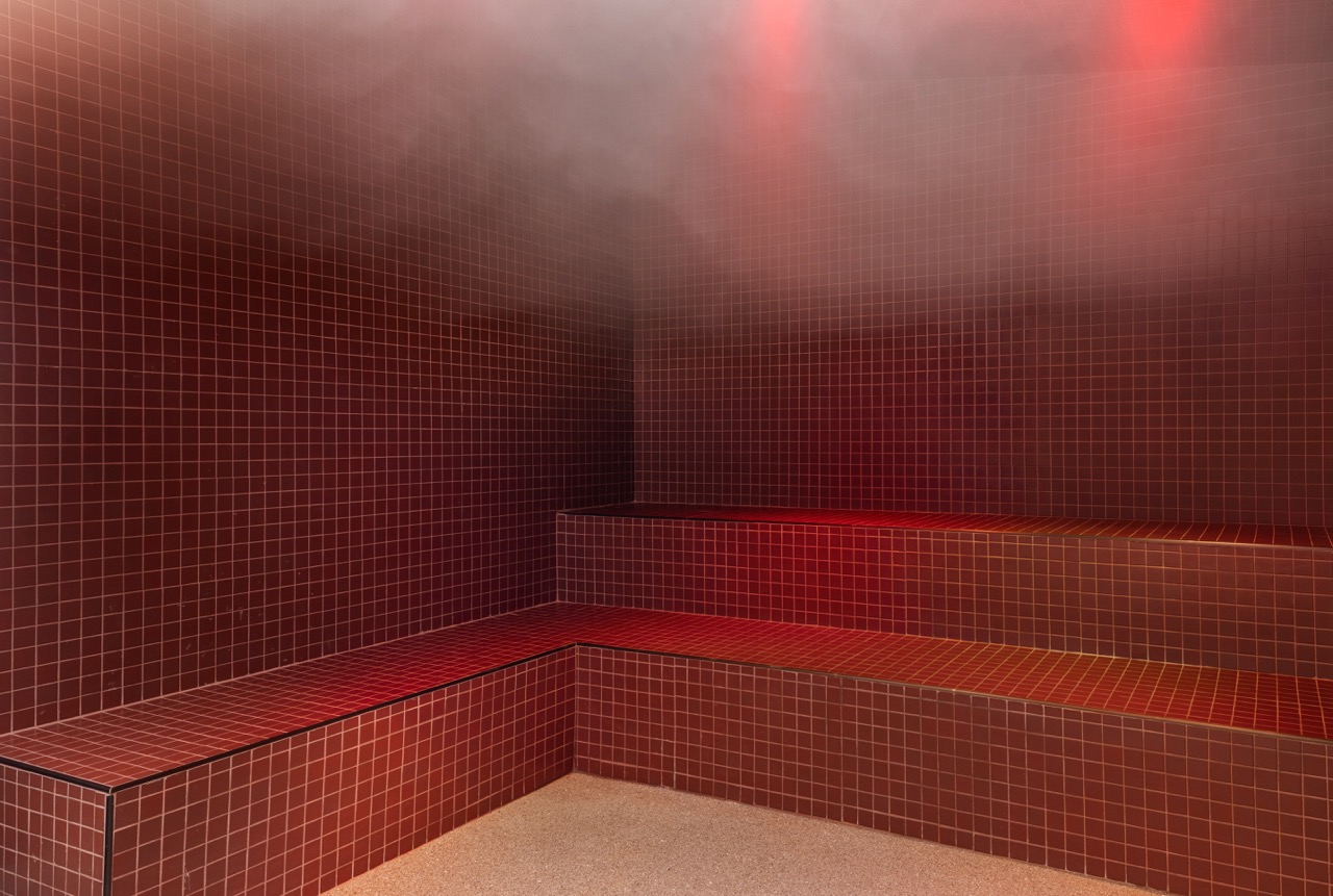 Red tiled interior with benches and a dark ceiling, no people present.