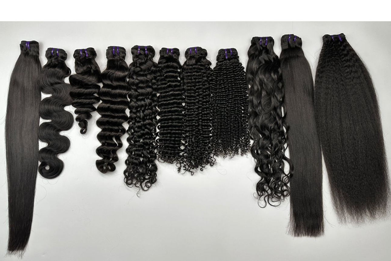 Collection of black hair extensions with various curl patterns and textures, arranged in a row on a white background.